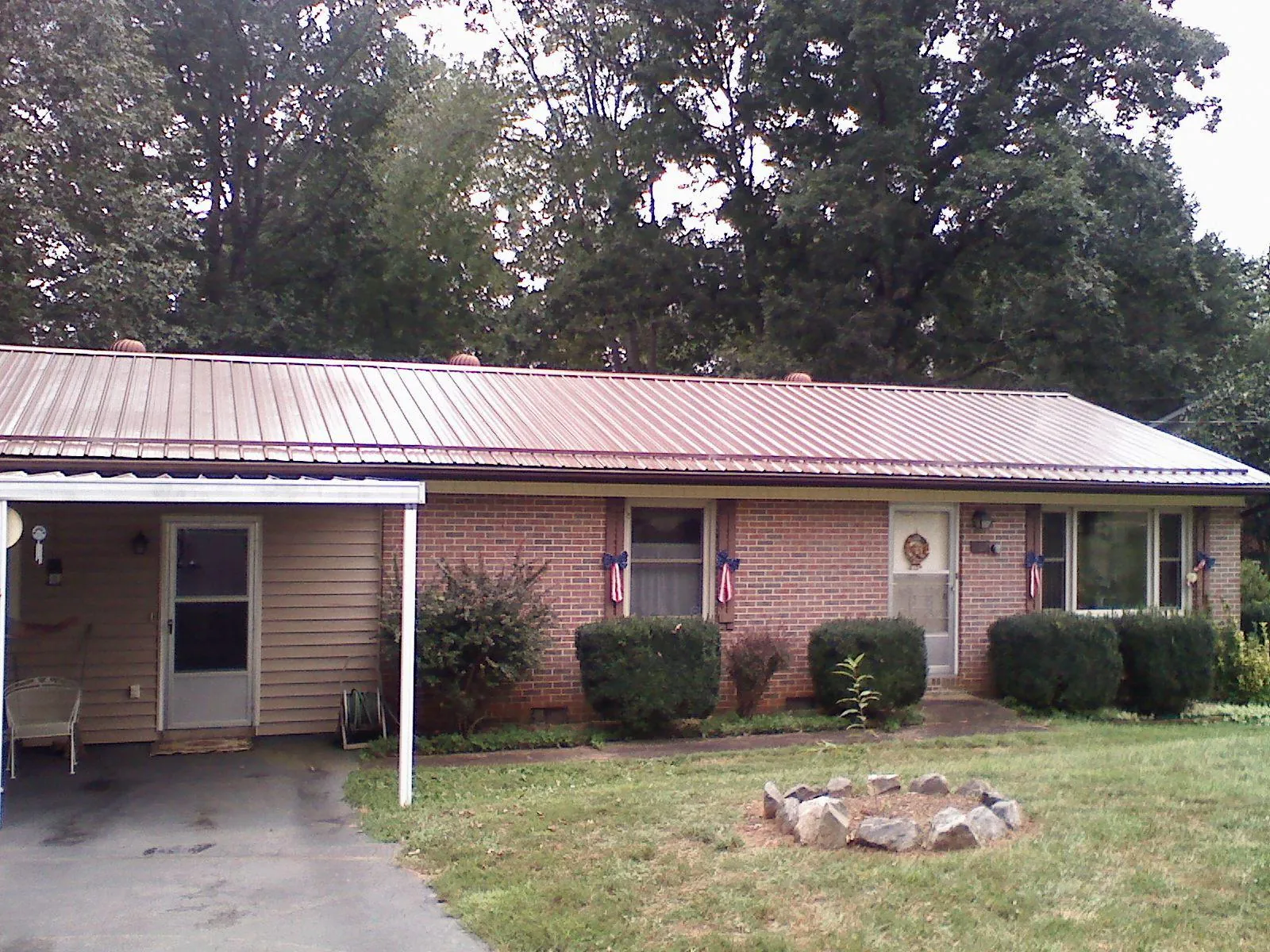 Bronze metal roof and carport on a brick ranch home — Roof Repair work by our crew in Cerulean
