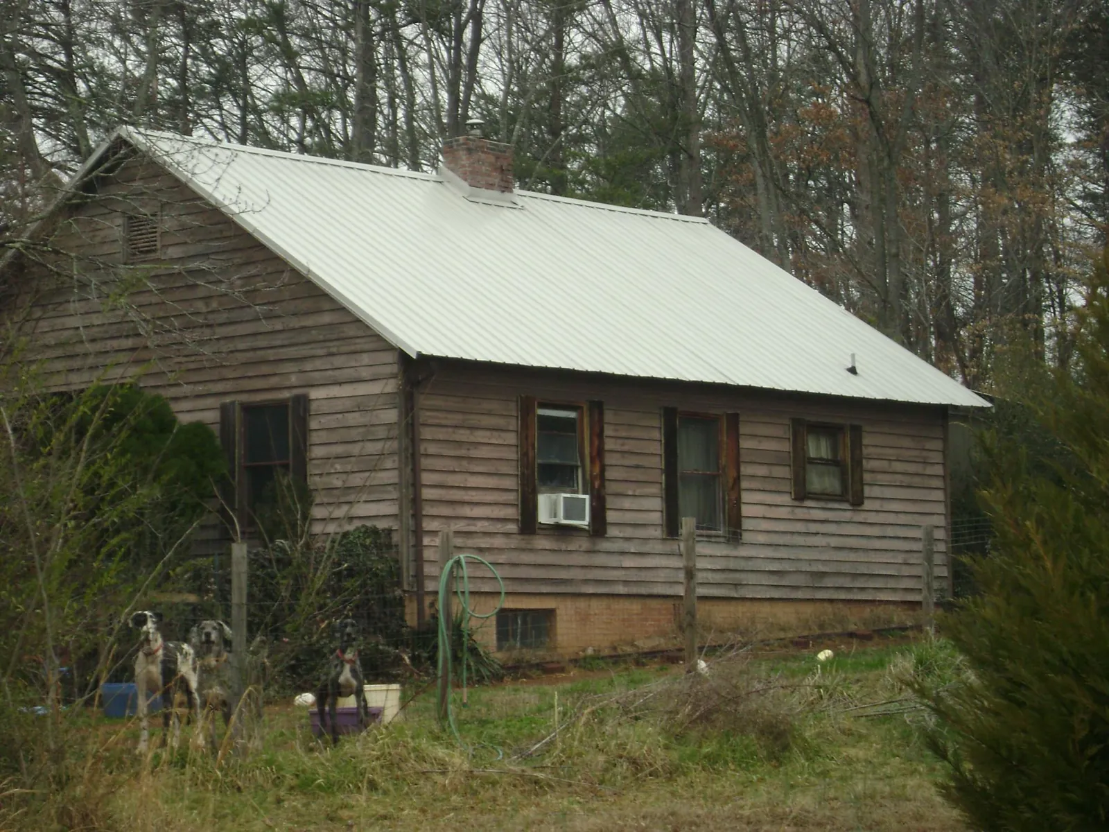 White metal roof on an old wood sided farmhouse, from a Metal Roof Installation job in Cerulean
